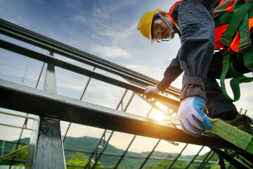 Wall Mural - Engineer technician Working at height equipment. Fall arrestor device for worker with hooks for safety body harness on selective focus. Worker as in construction background.