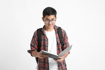 Education concept : Indian college student holding bag and reading book on white background