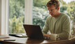 © Jacob Lund - Young man working on laptop indoors