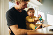 © Jacob Lund - Man spending quality time with his adorable child at home