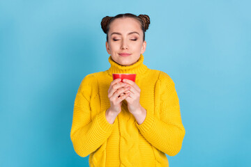 Sticker - Portrait of attractive cheerful dreamy girl drinking smelling tasty cacao isolated over bright blue color background