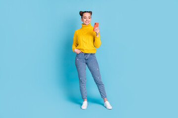 Wall Mural - Full length body size view of pretty cheerful girl using device chatting isolated over vibrant blue color background