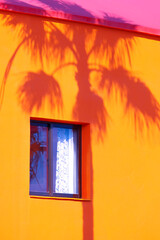 Wall Mural - Fashion tropical location. Palm shadows. Yellow house. Canary islands. Travel advertising banner wallpaper