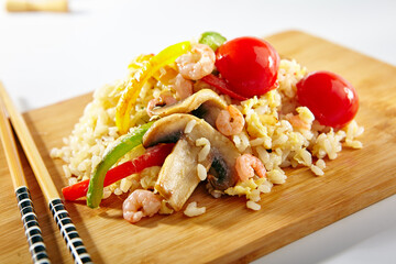 Canvas Print - Chicken Fried Rice with Vegetables. Asian style food on white background. Wooden dish with chopsticks.