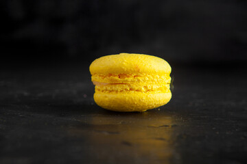 Wall Mural - colored fresh macarons in studio on black background