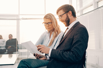 Wall Mural - businessman and businesswoman discussing a business document.