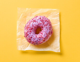 Wall Mural - pink donut on yellow background