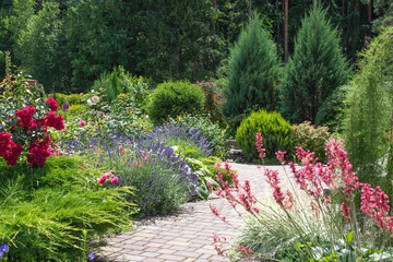 Wall Mural - Garden design. Beautiful landscape with garden corner. Blooming flowers background