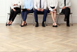 © New Africa - People waiting for job interview in office hall, closeup