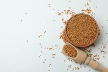 Scoop And Bowl With Mustard Seeds On White Background