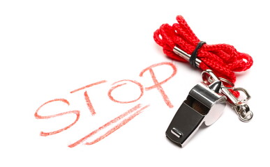 Metallic silver sports whistle attached to red rope with word stop isolated on white background