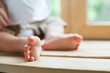 © Olga Mishyna - Small baby feet. Kid of one year old crawls on the floor. Small legs. First birthday