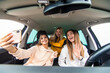 © F8  \ Suport Ukraine - Three women having fun in the car and taking selfies with phone