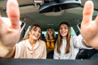 © F8  \ Suport Ukraine - Three beautiful young cheerful women making selfie on phone and smiling while sitting in car together