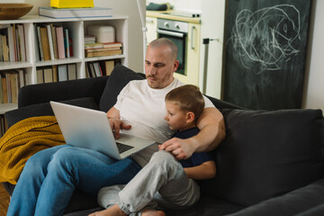 Wall Mural - father and son using laptop computer