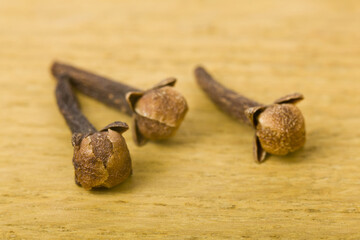 Sticker - Spice cloves on a wooden table close-up.