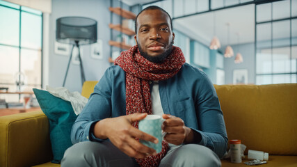 Aufkleber - Point of View from Camera with Sick Black African American Calling into Office with Video Call from Cozy Living Room. Ill and Nauseous Male in Warm Scarf Talking to Friend Over a Live Camera.
