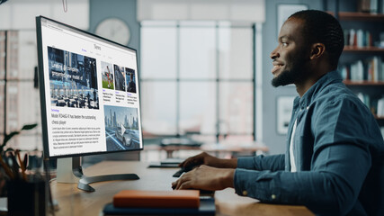 Poster - Handsome Black African American Specialist Working on Desktop Computer in Creative Home Living Room. Freelance Male is Reading News for Financial Market Analysis and Report for Clients and Employer.