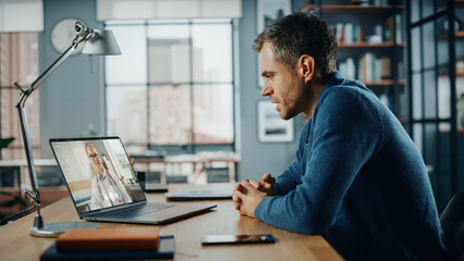 Aufkleber - Handsome Caucasian Man Having a Video Call with Female Doctor on Laptop Computer while Sitting Behind Desk in Living Room. Freelancer Working From Home and Talking a Medic Over the Internet.