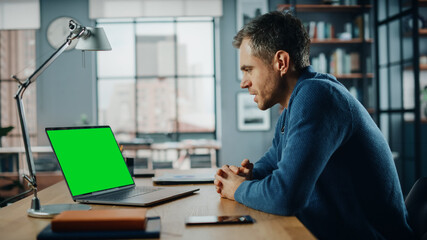 Aufkleber - Handsome Caucasian Specialist Chatting on Video Call on Laptop with Green Screen Mock Up Display at Home Living Room. Freelance Man Chatting to Clients Over Internet on Social Networks.