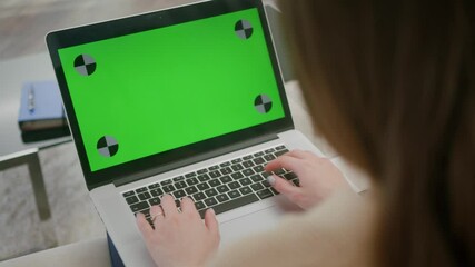 Business woman working at home office looking at screen of laptop. Student girl using laptop, typing keyboard laptop green screen. Close up hands working on laptop.