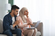 © Prostock-studio - Labor And Delivery Fears. Worry Muslim Couple Watching Childbirth Videos On Laptop