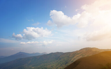 Green valley and mountain range with moody sky	
