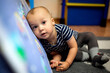 little boy 1 year old playing at home, selective focus