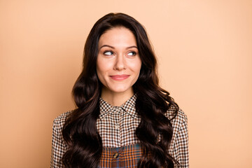 Photo of young attractive woman happy positive smile dream dreamy look empty space isolated over beige color background