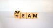 © Dzmitry - Dream team symbol. Turned the cube and changed the word 'dream' to 'team'. Beautiful white table, white background. Business and dream team concept, copy space.