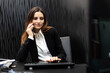 Young secretary on the phone in her office