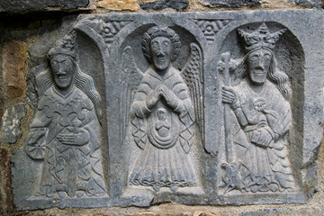 Wall Mural - detail of a stone carving of three religious figures
