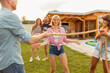 © Impact Photography - Friends doing the limbo dance at backyard party