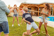 © Impact Photography - Friends doing the limbo dance at an outdoor summertime party