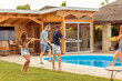 © Impact Photography - Friends splashing water on each other with squirt guns