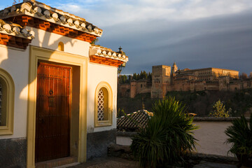 View of the Alhambra palace complex across the Darro valley from Placeta Comino, El Albaicín, Granada, Andalusia, Spain