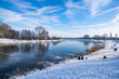 beautiful frozen river called werdersee at sunny warm white winter day with snowy dike in bremen