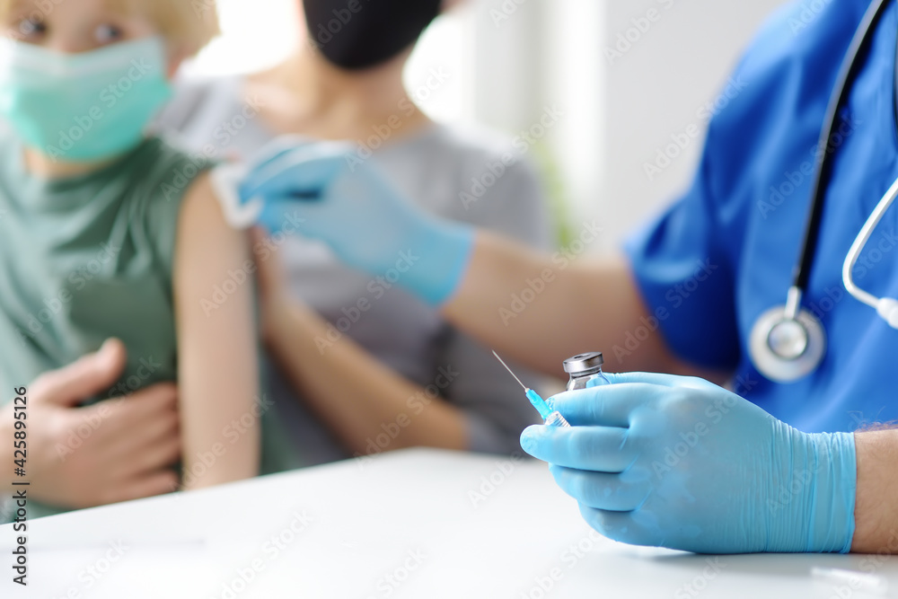 Doctor or nurse is preparing to give a injection vaccine against covid-19 to a little child. Vaccination of children. Herd immunity - obrazy, fototapety, plakaty 