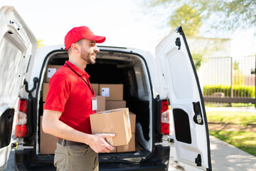 Wall Mural - Side view of a courier working and delivering parcels