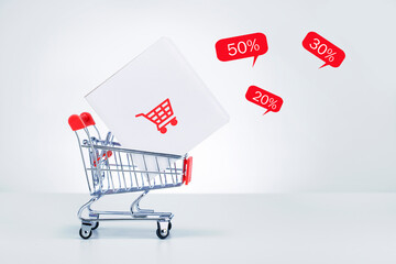 Shopping trolley with delivery box and sale of special offers. Black Friday Sale Concept.