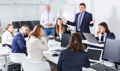 Wall Mural - Irritated boss scolding subordinates, pointing out shortcomings and misses in work