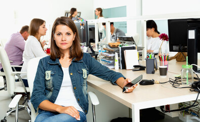 Wall Mural - Portrait of young glad cheerful positive female freelancer confidently smiling at workplace in coworking space