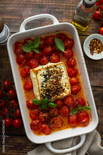 Obraz Dibond Baked feta cheese with cherry tomatoes in a pan
