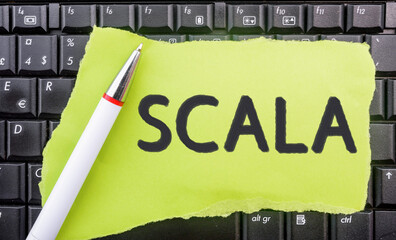 Poster - Scala programming language. Word Scala on paper and laptop