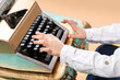 © beauty_objects - Close-up hands of boy typing on classic typewriter