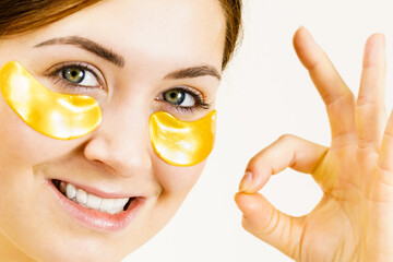 Wall Mural - Woman with gold patches under eyes