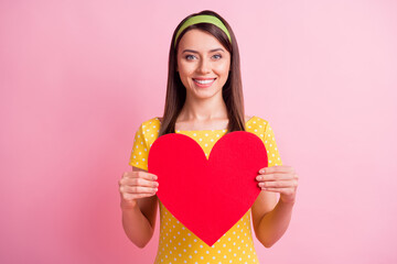Wall Mural - Photo of young attractive smiling cheerful good mood girl hold present big red heart isolated on pink color background