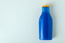 Blank Blue Bottle Of Sunscreen On White Background