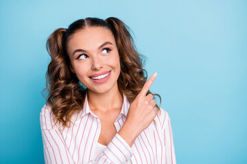 Sticker - Portrait of lovely cheerful brown-haired girl demonstrating copy empty blank space advert isolated over vivid blue color background