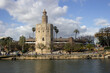 Gold Tower called Torre del Oro, along the Guadalquivir River in a cloudy promenade in Seville, the capital of Andalusia, in southern Spain. 